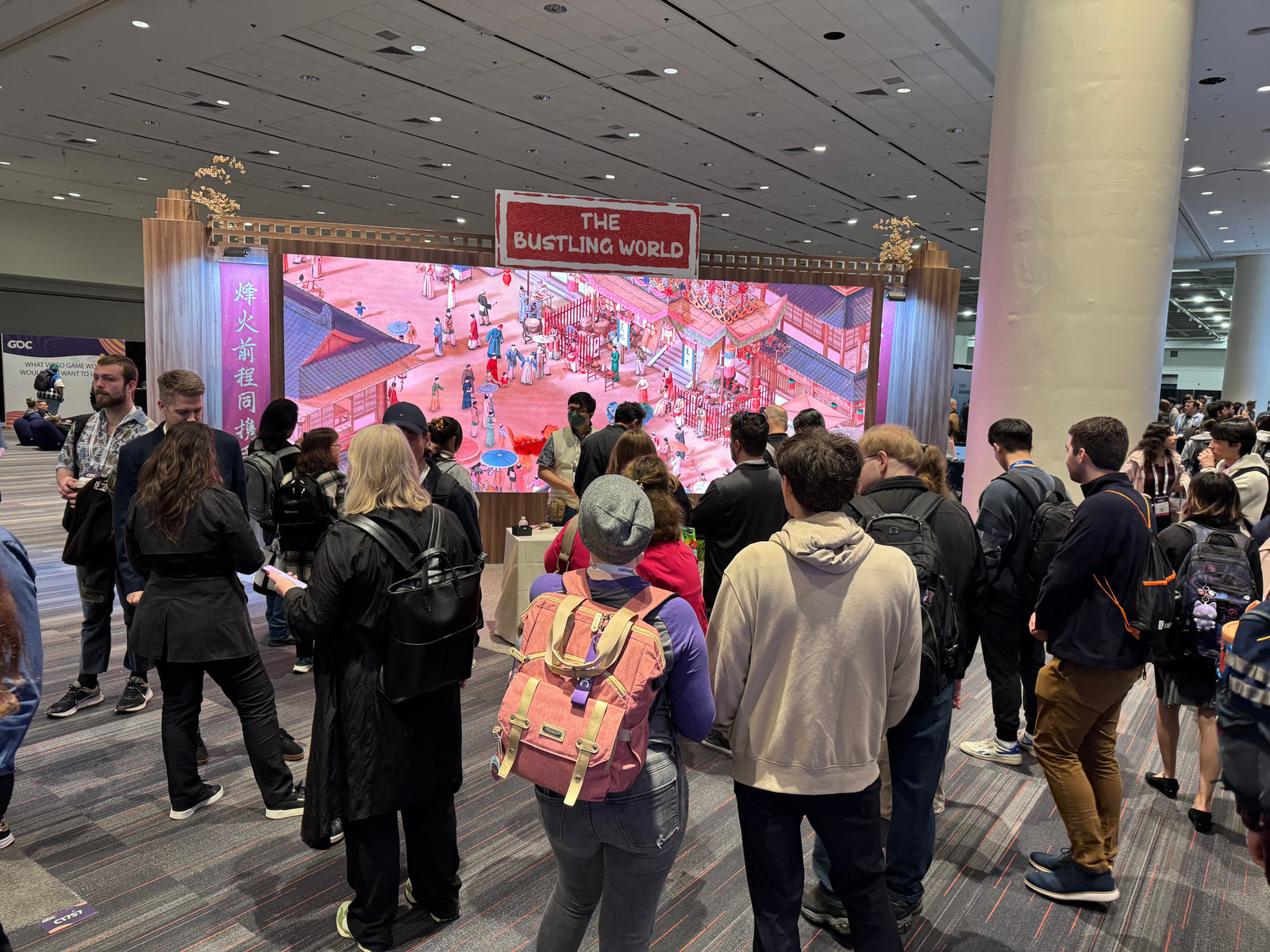 Visitors gathering around a game showcase at GDC